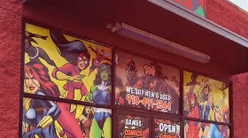 The storefront's painted comic-art windows